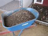 Now we top it off with 6 loads of pee-gravel.&nbsp; This provides a nice thick soft sanitary bed for the dogs to lounge on.&nbsp; 